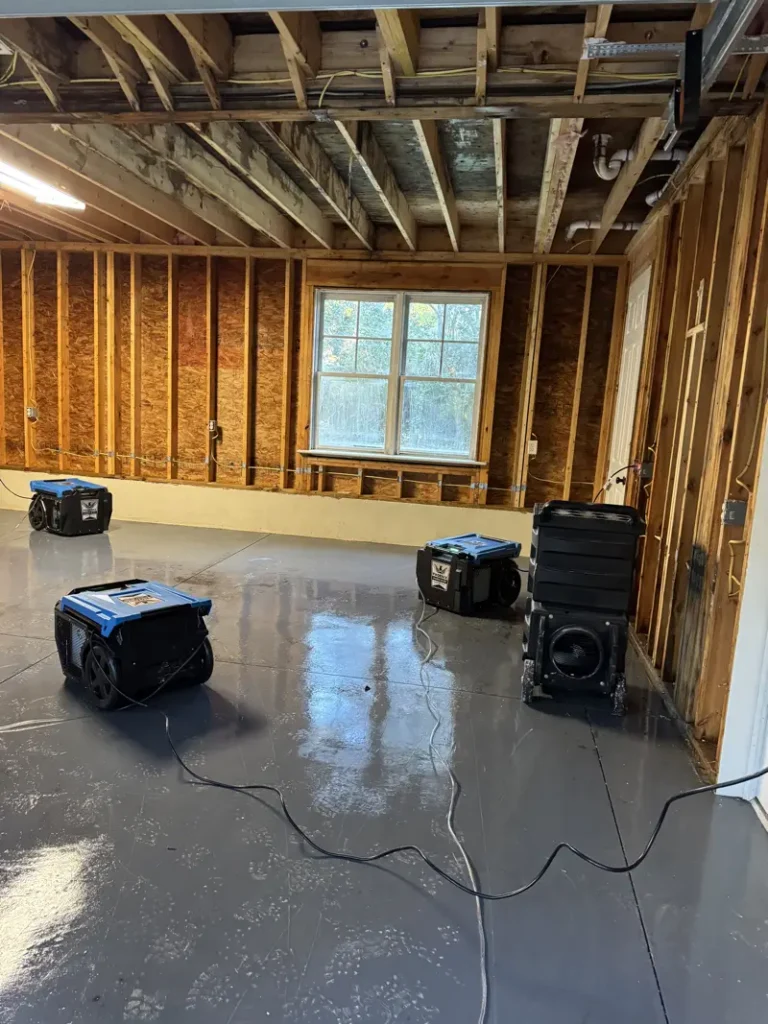 Professional water damage restoration drying equipment and air movers set up to dry a residential property after water damage.